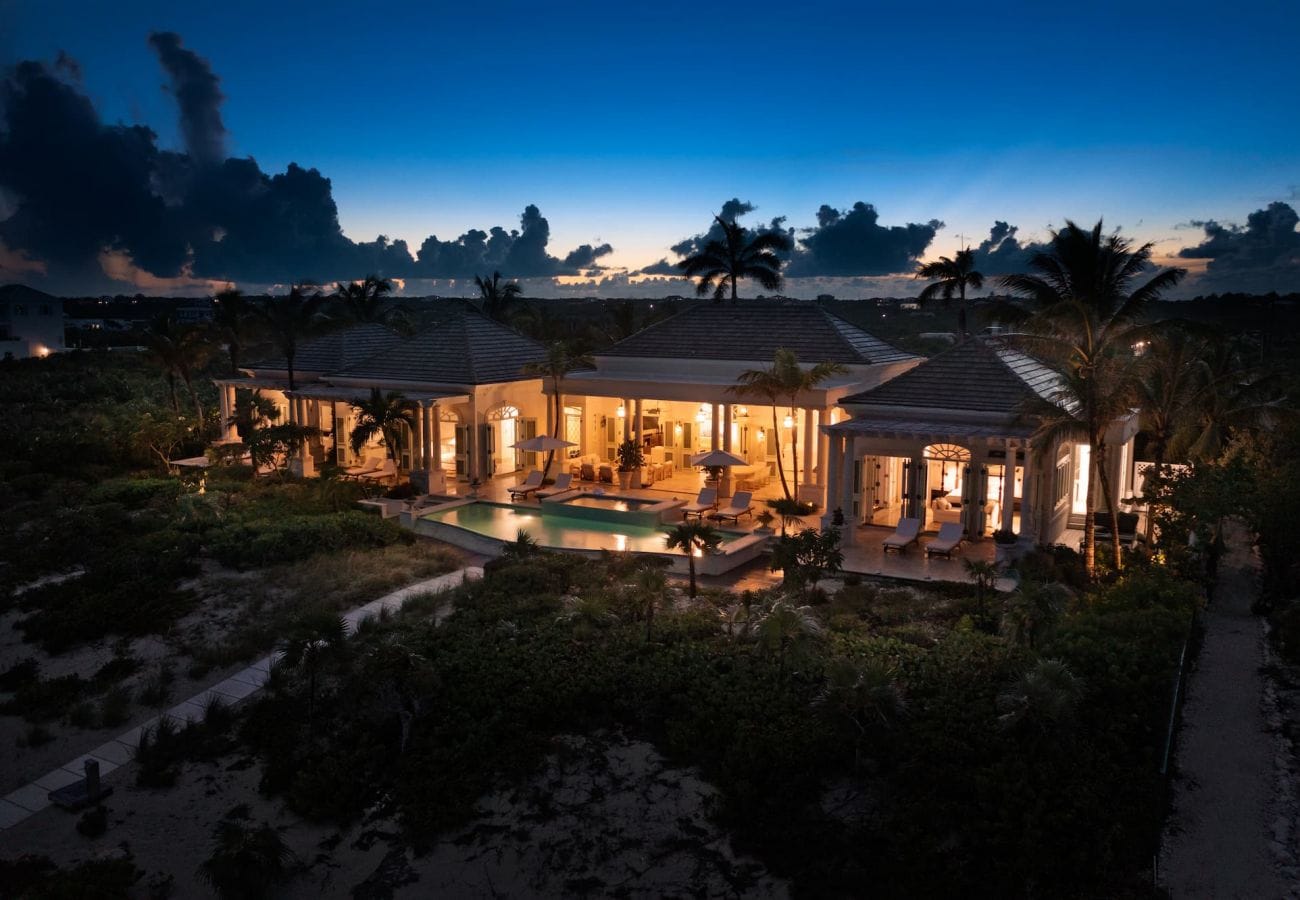 Luxury villa at dusk, illuminated.