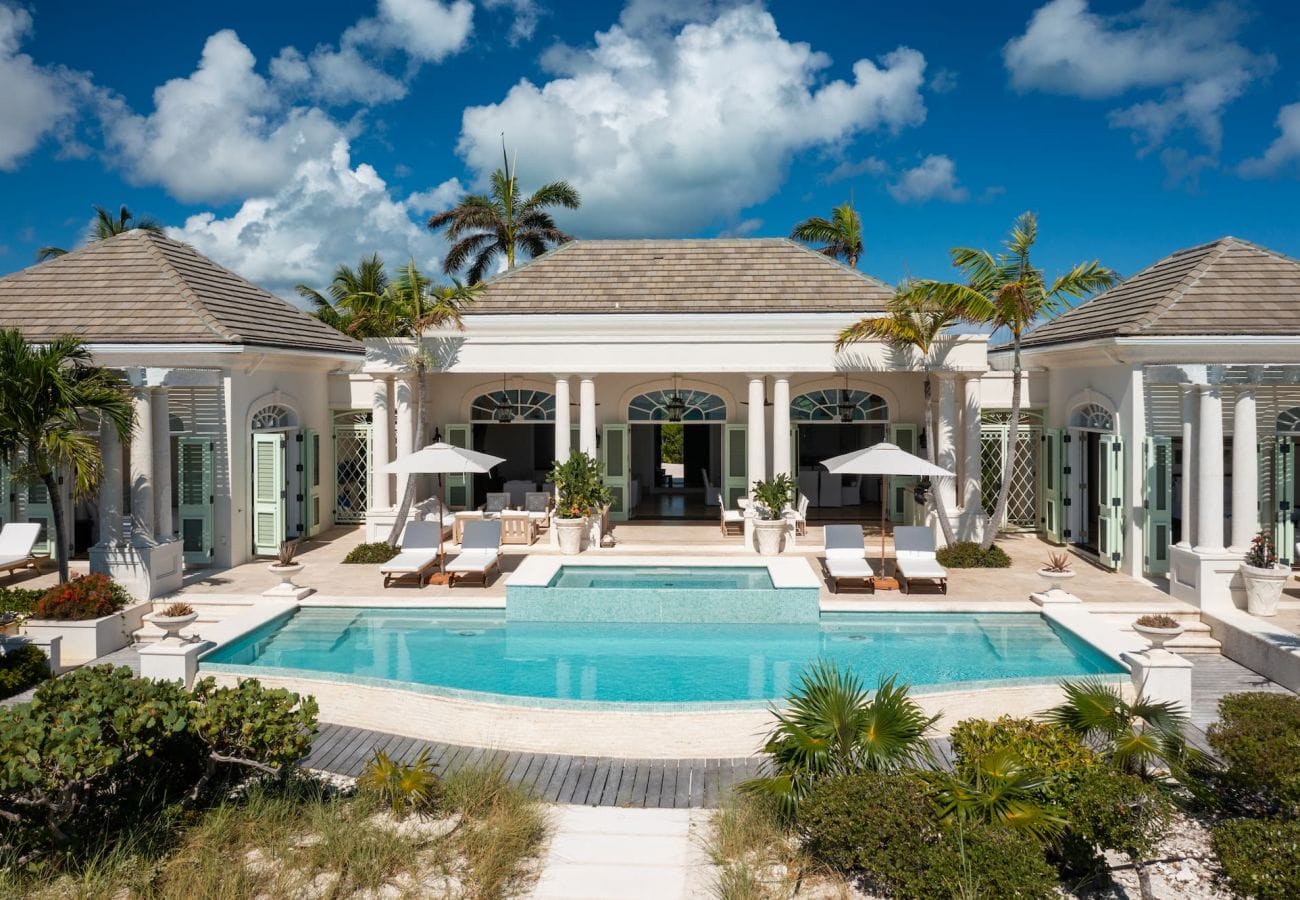 Luxury villa with pool and palms.