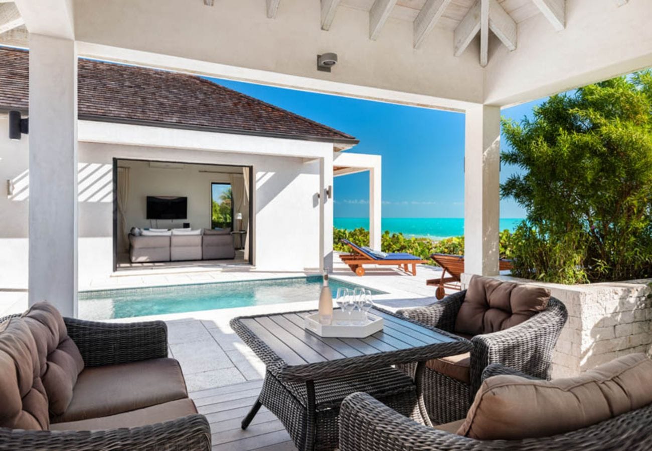 Outdoor patio overlooking pool and ocean.