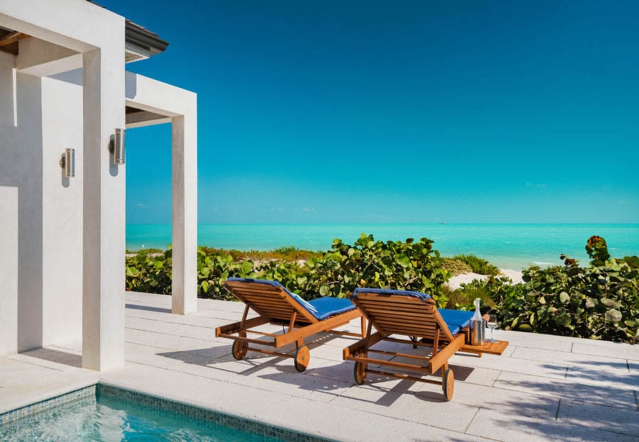 Poolside lounge chairs, ocean view.