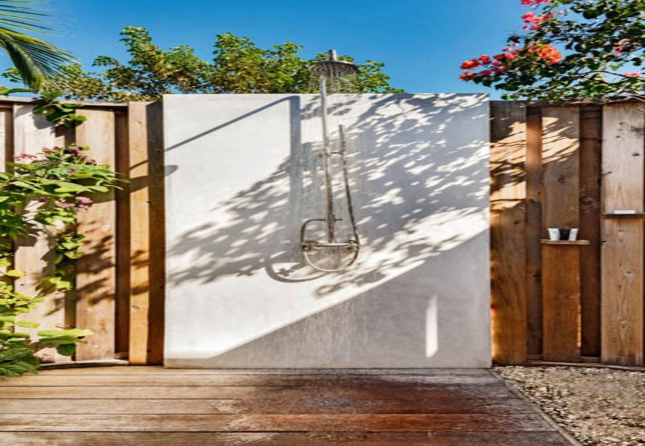 Outdoor shower with wooden enclosure.