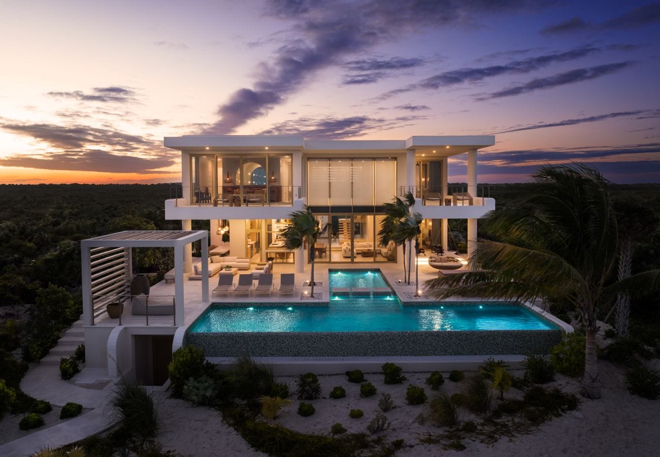 Modern house with pool at dusk.