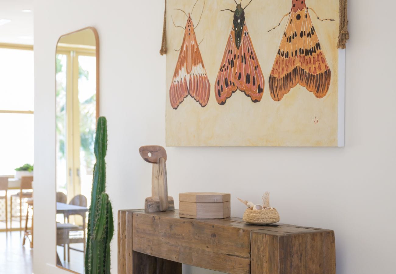 Interior with moth artwork, cactus.