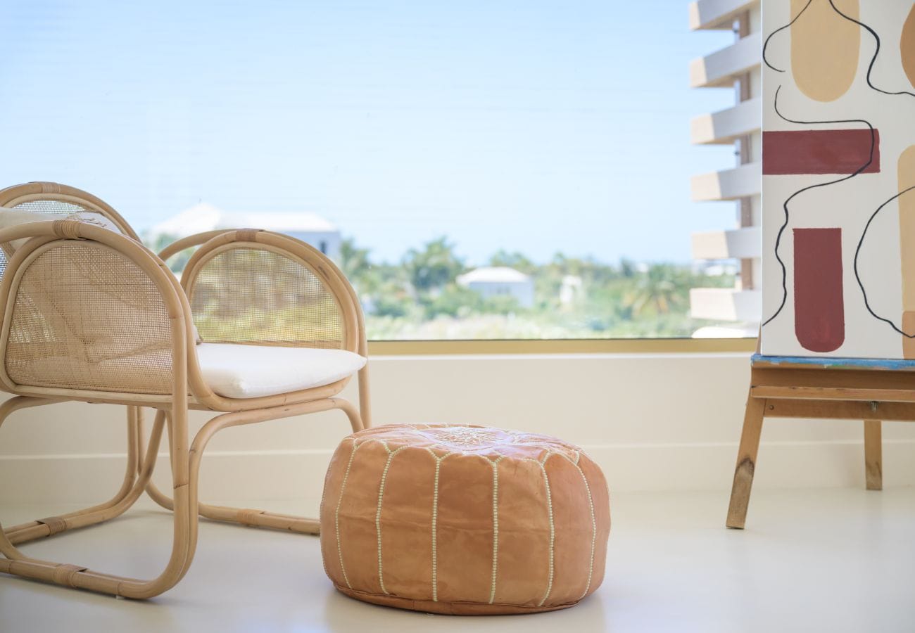 Chair, pouf, and abstract painting.