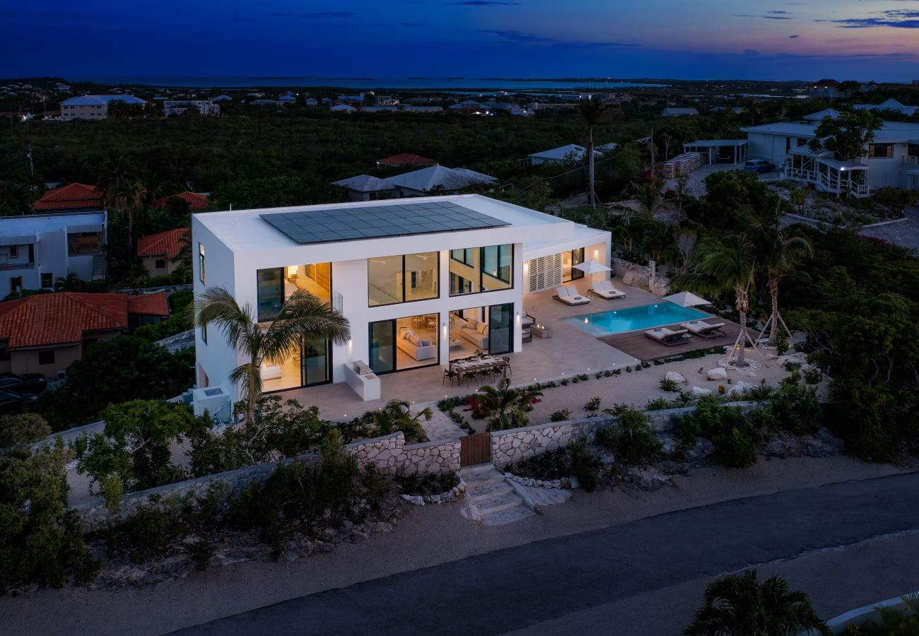 Modern house with pool at dusk.