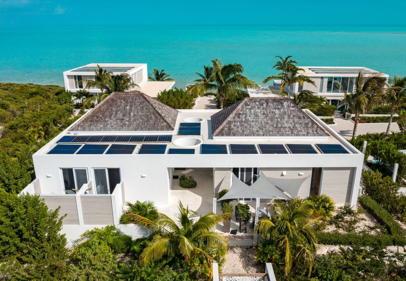 Modern beachfront house with solar panels.