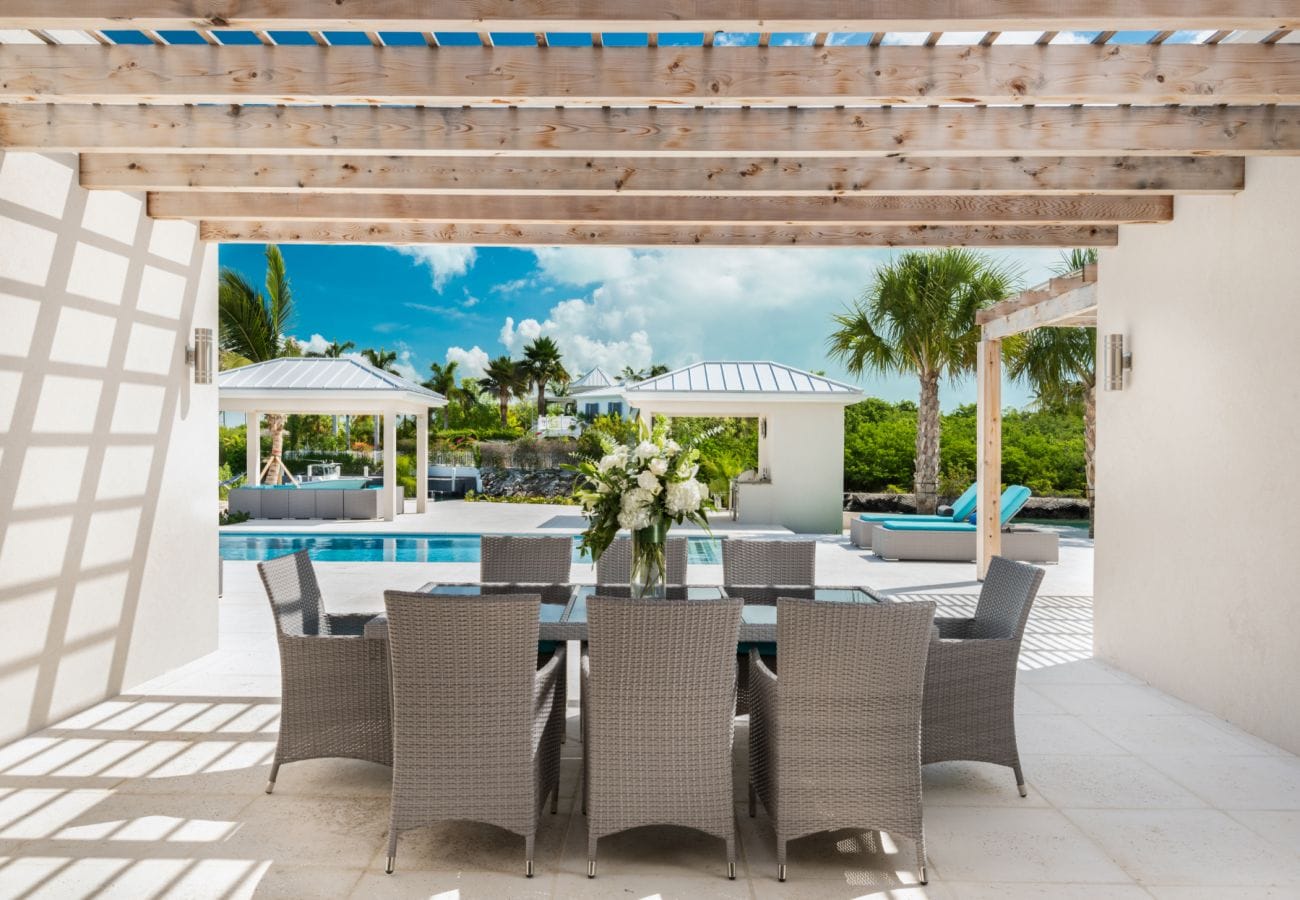 Outdoor patio with pool view.