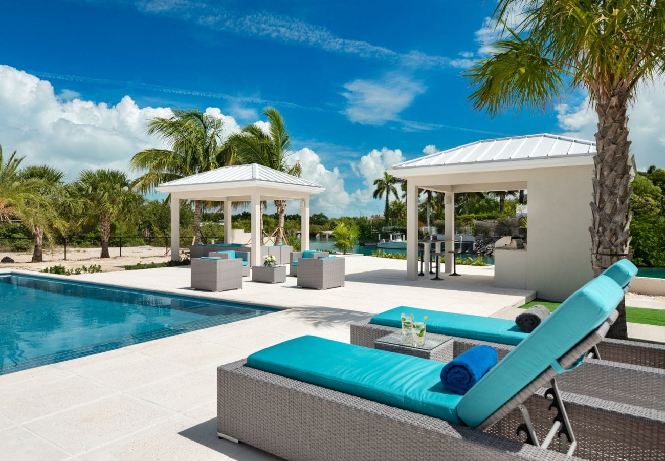 Poolside patio with tropical seating.