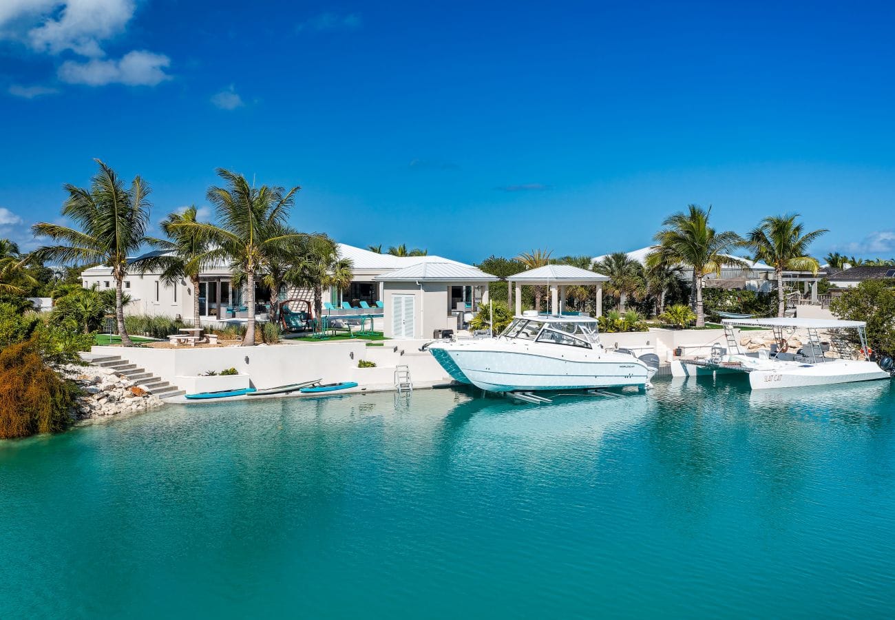 Tropical waterfront home with boats.