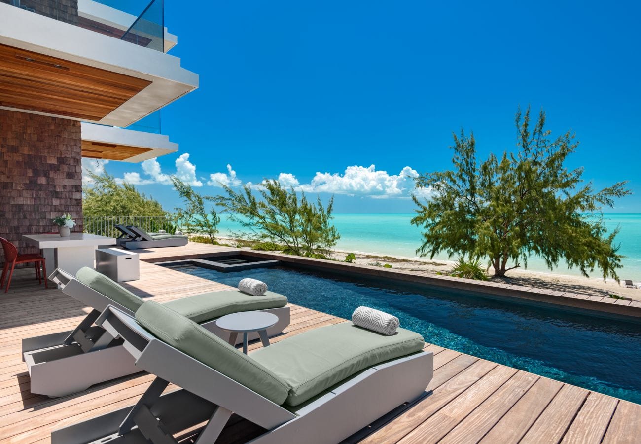 Beachfront pool with lounge chairs.