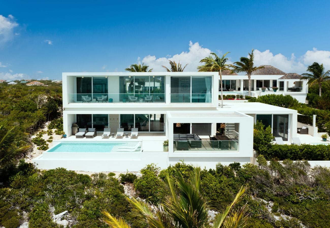 Modern villa with pool and greenery.