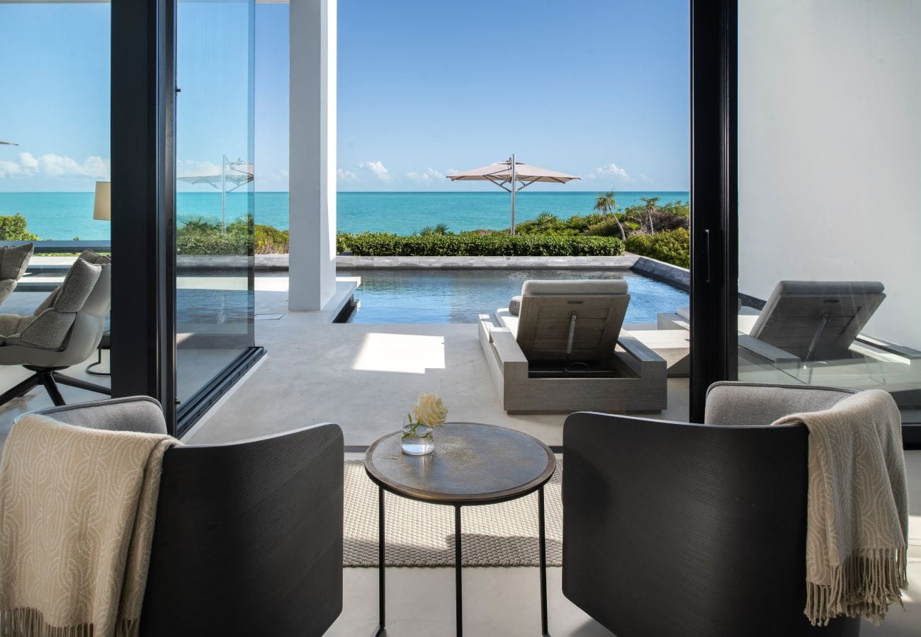 Modern patio overlooking pool and ocean.