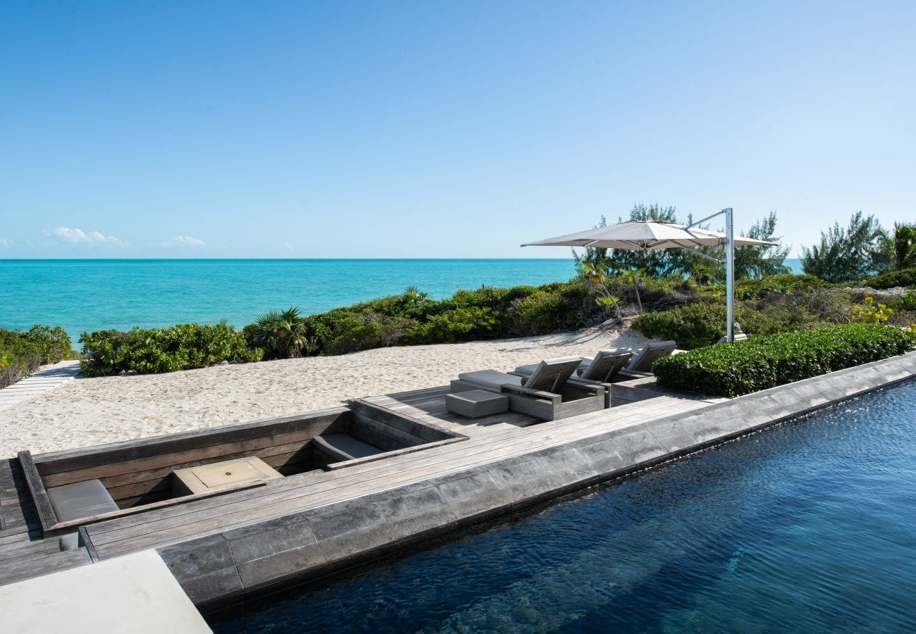 Beachfront deck with lounge chairs.