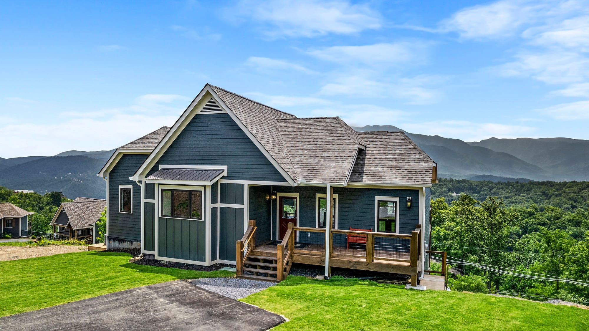 Blue house with mountain backdrop.