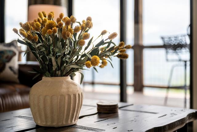 Yellow flowers in ceramic vase.