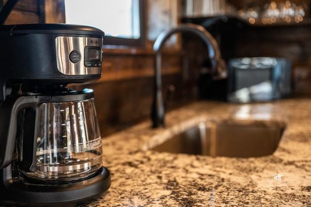 Coffee maker on granite countertop.