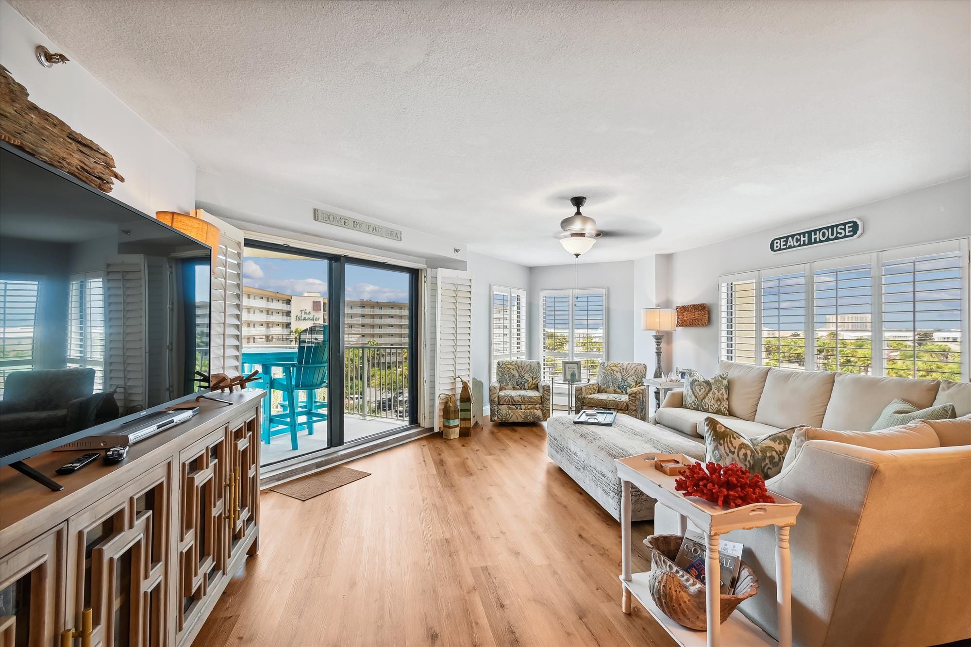 Coastal-themed living room with balcony.