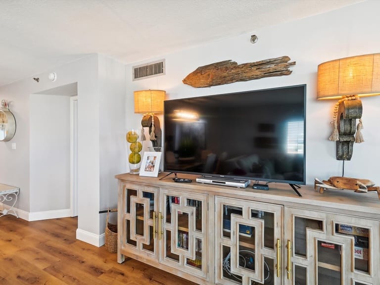 Living room with TV and cabinet.