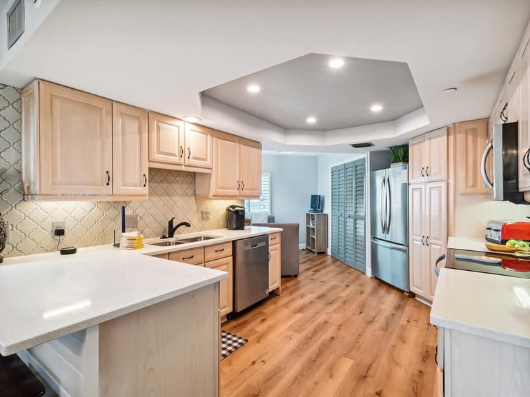 Modern kitchen with wood flooring.