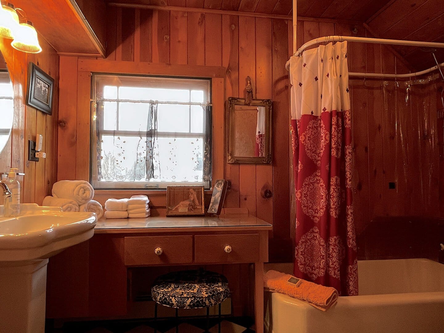 Cozy wooden bathroom with shower curtain.