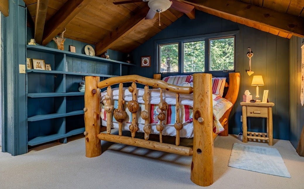 Cozy cabin bedroom with wooden bed.