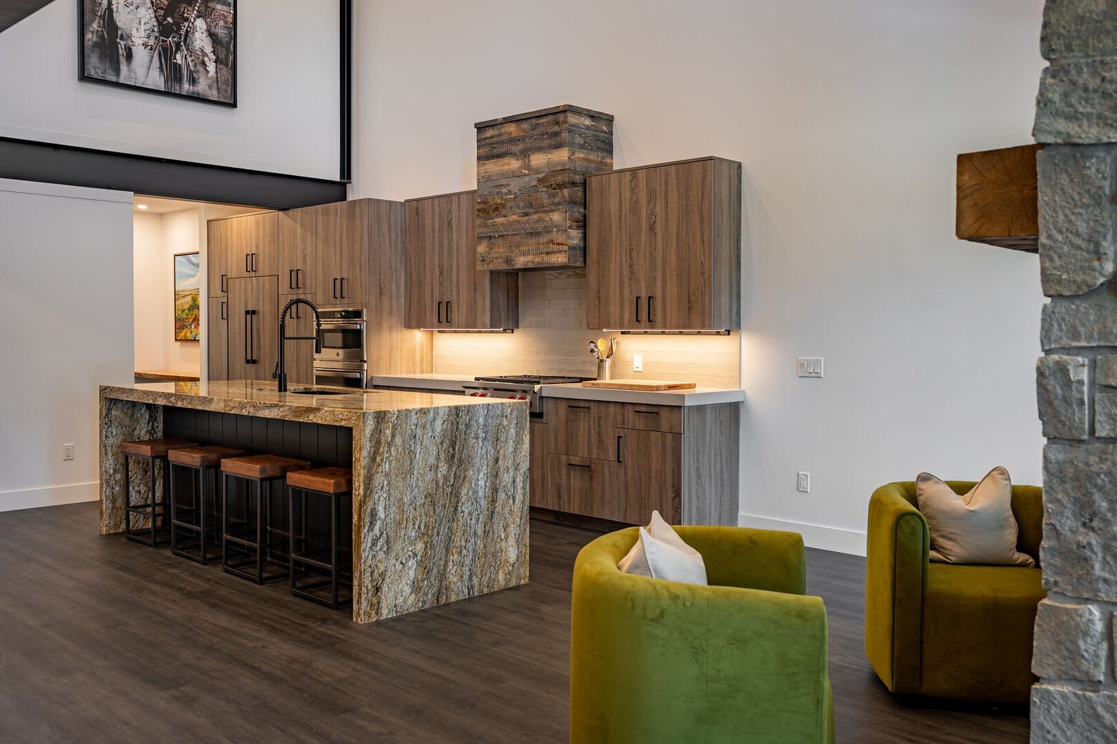 Modern kitchen with green chairs.