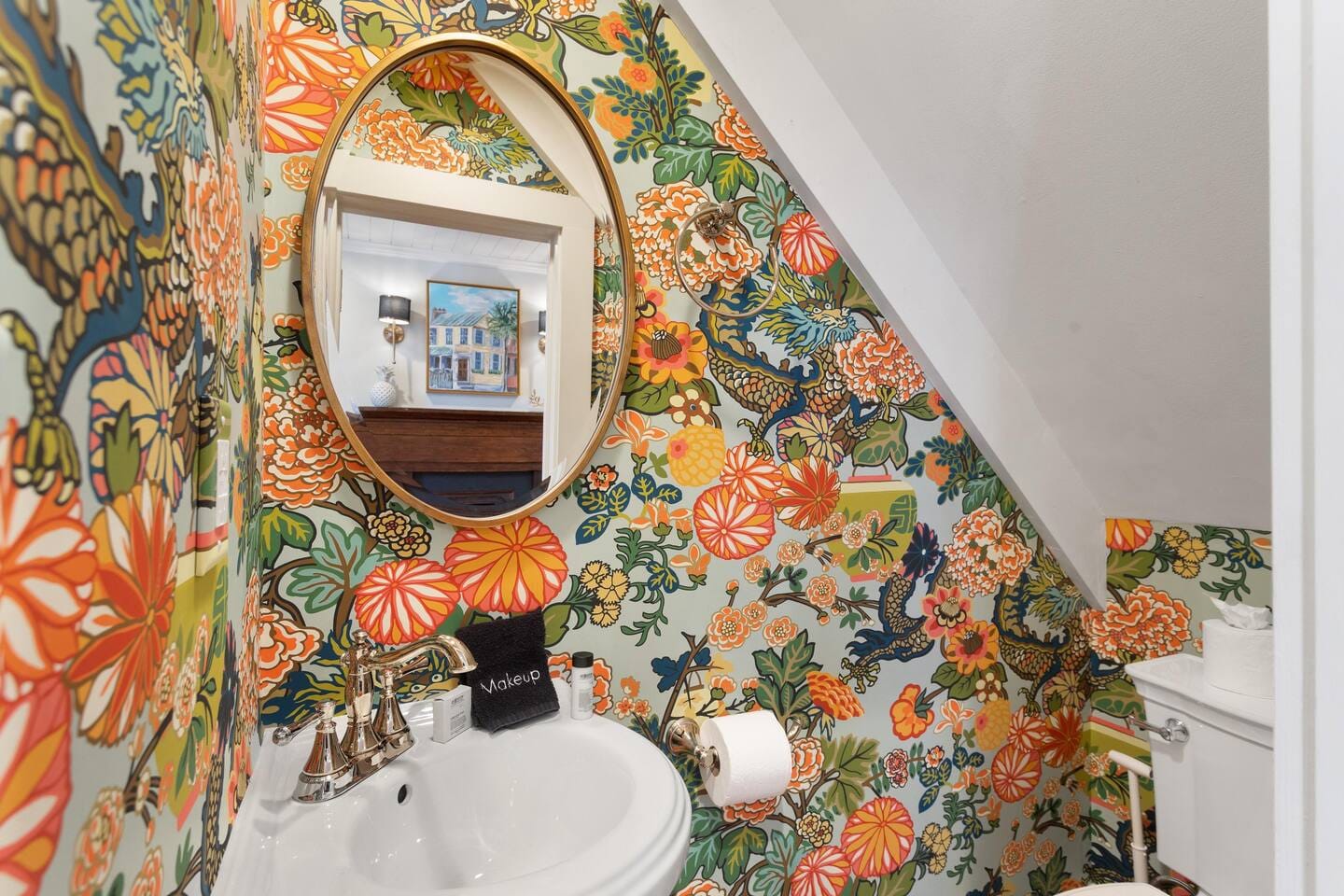 Vibrant bathroom with floral wallpaper.