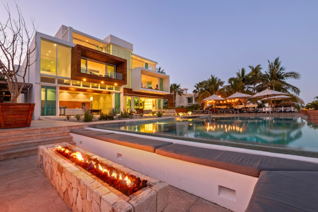 Modern villa with pool and firepit.