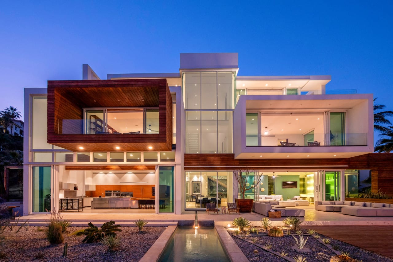 Modern house with large glass windows.