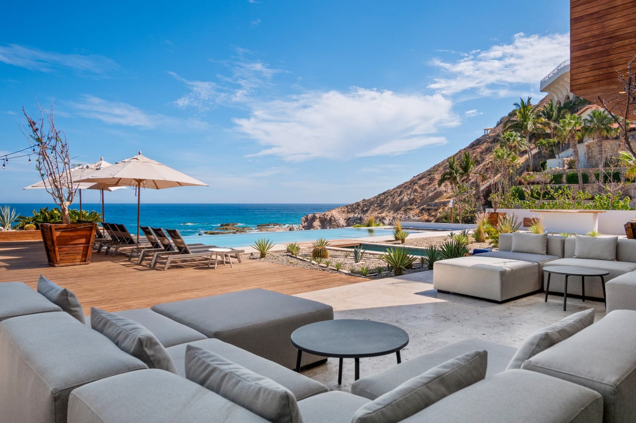 Luxury oceanfront patio with seating.