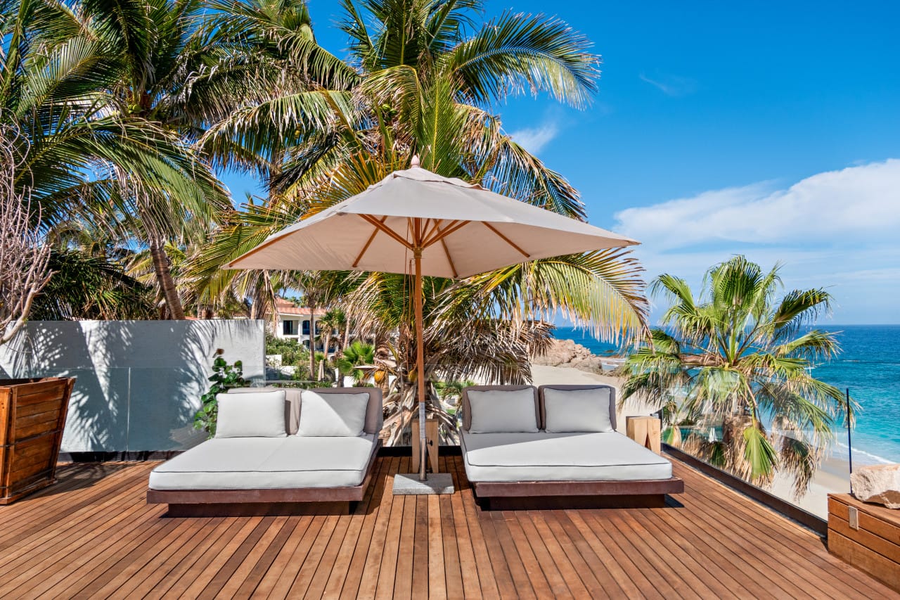 Beachfront deck with lounge chairs.