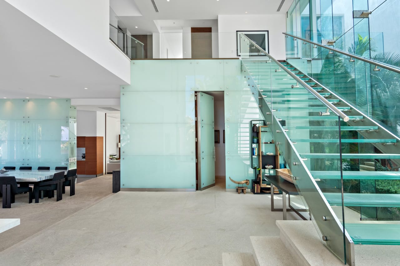 Modern interior with glass staircase.