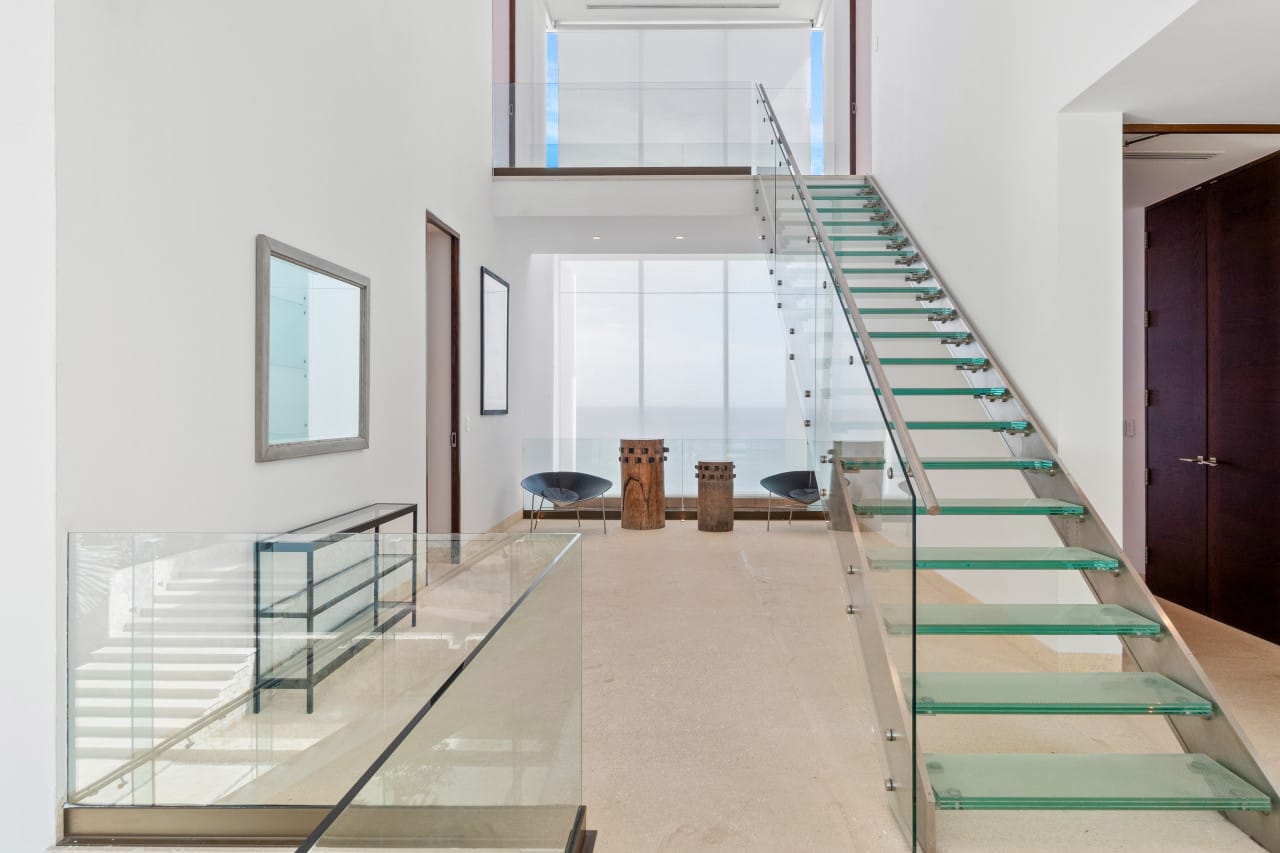 Modern interior with glass staircase.