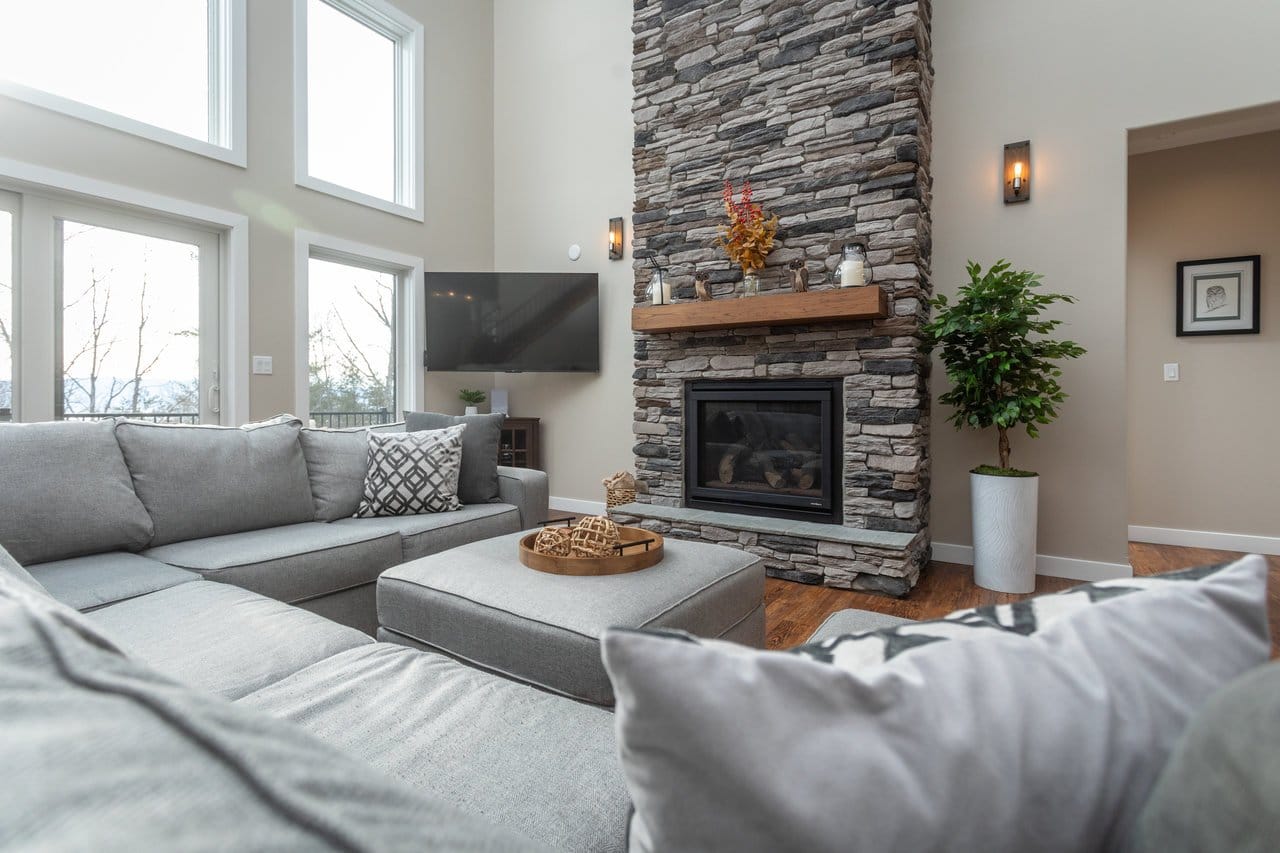 Modern living room with stone fireplace.