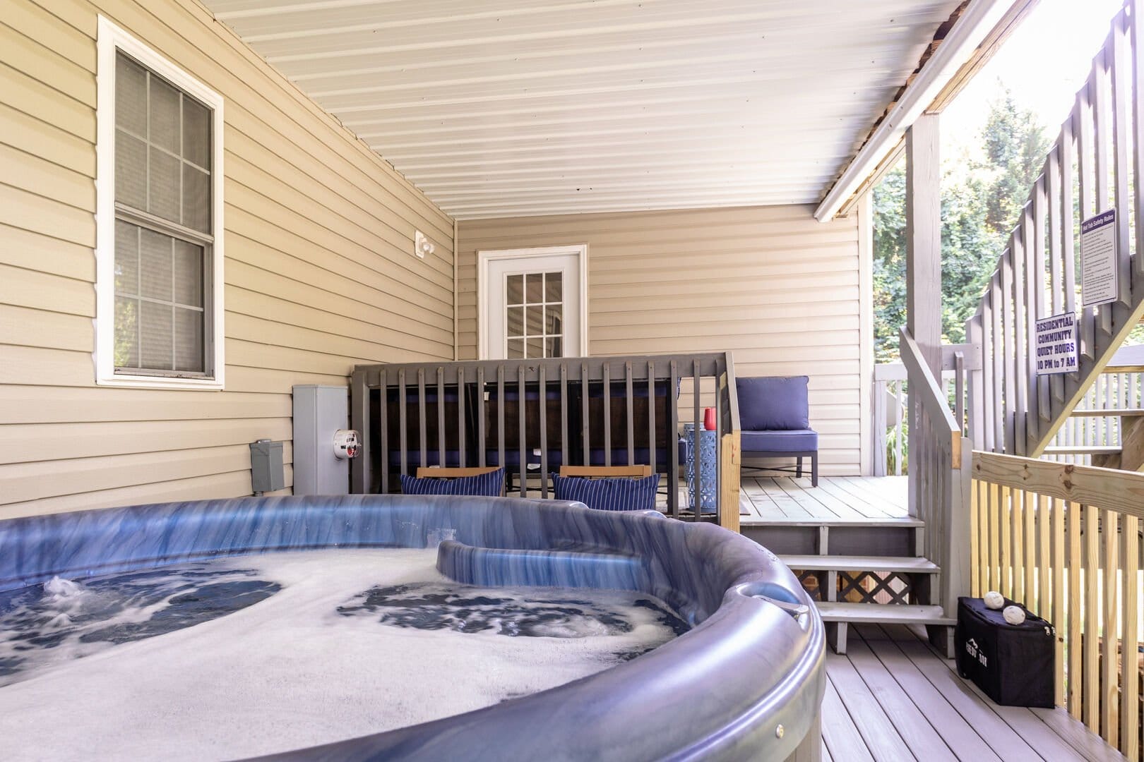 Covered porch with hot tub.