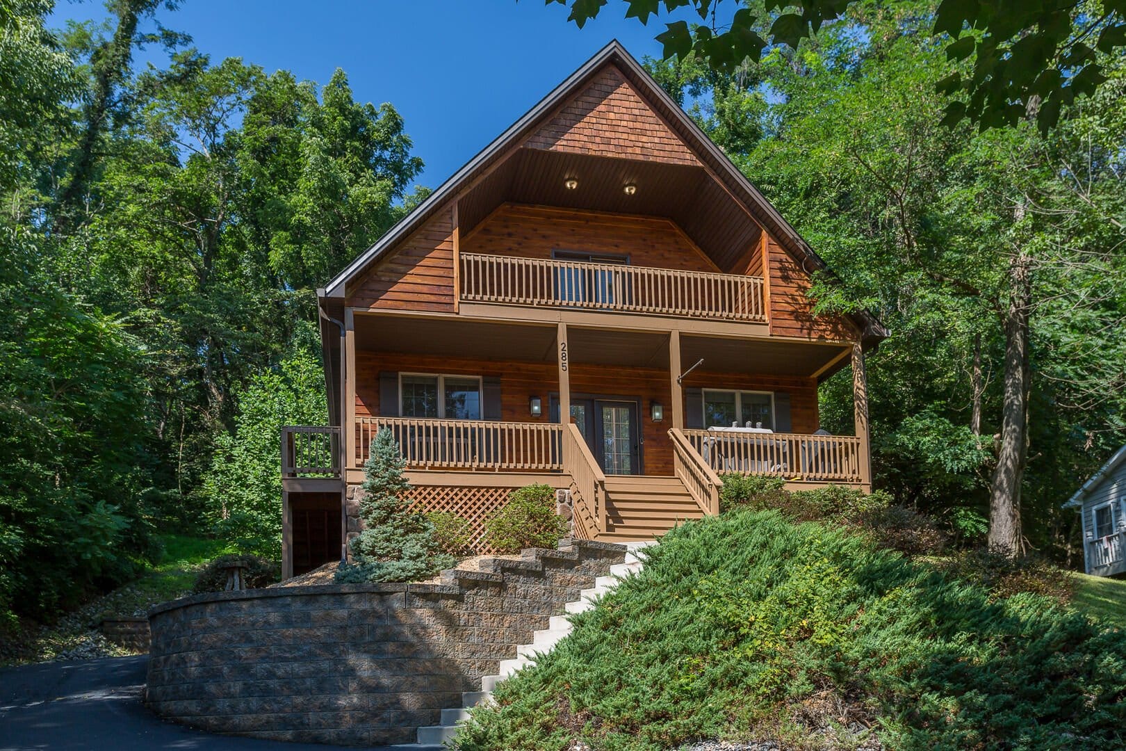 Wooden cabin surrounded by trees.