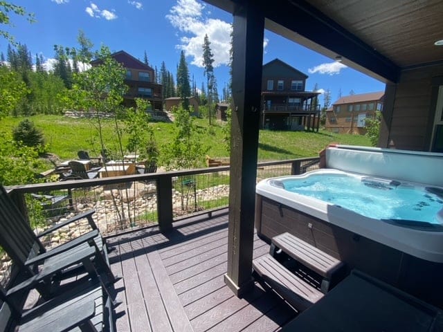 Deck with hot tub and chairs.