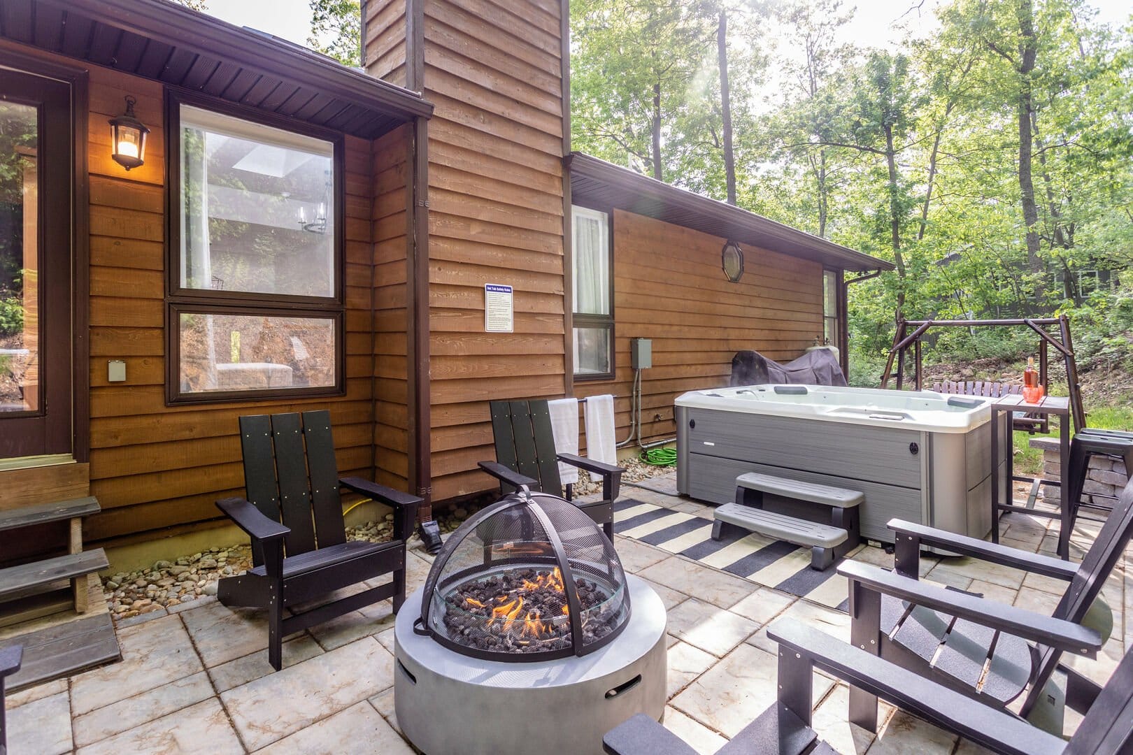 Outdoor patio with fire pit, hot tub.