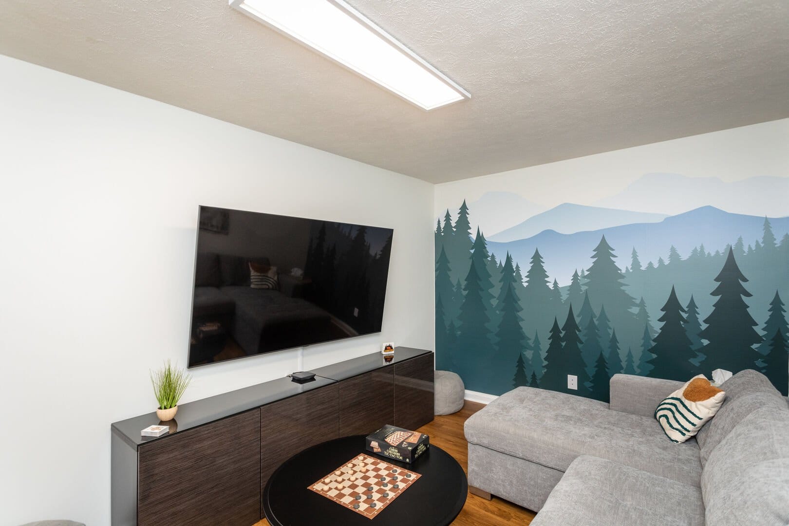 Living room with forest mural.