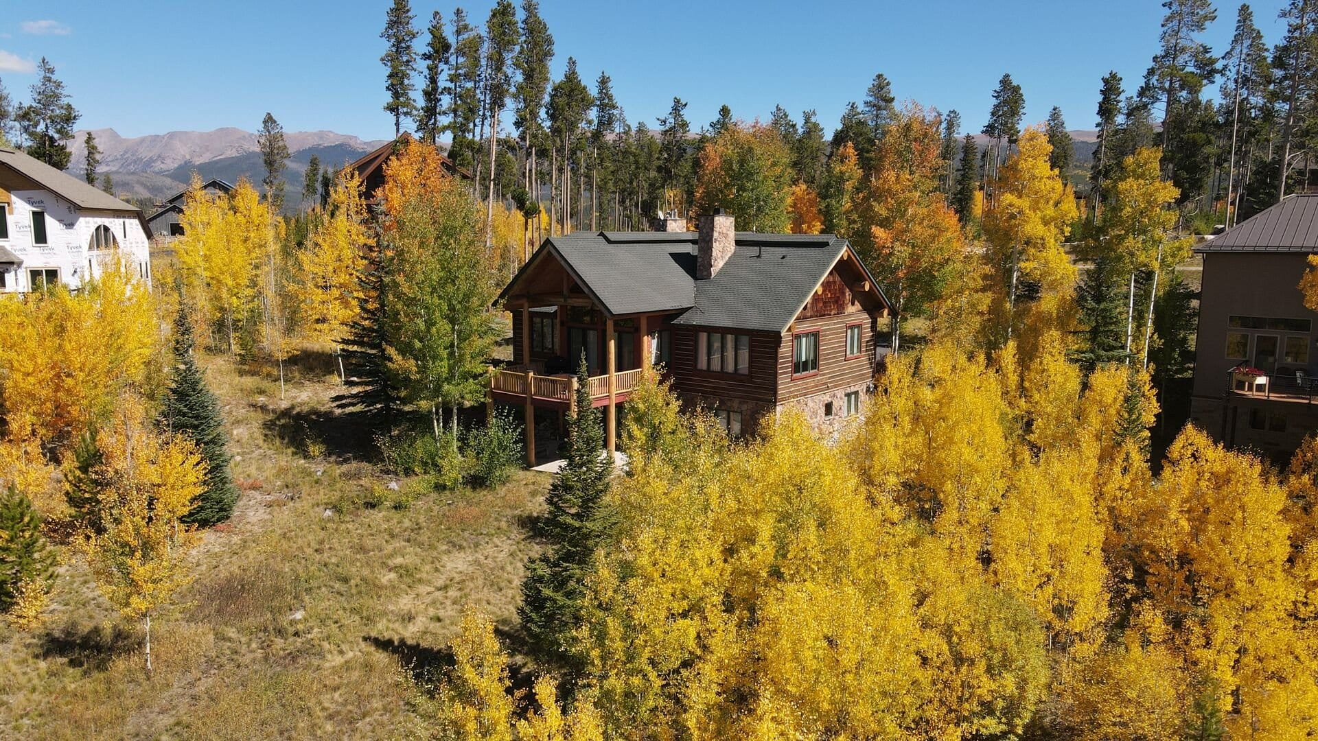 Cabin surrounded by autumn trees.