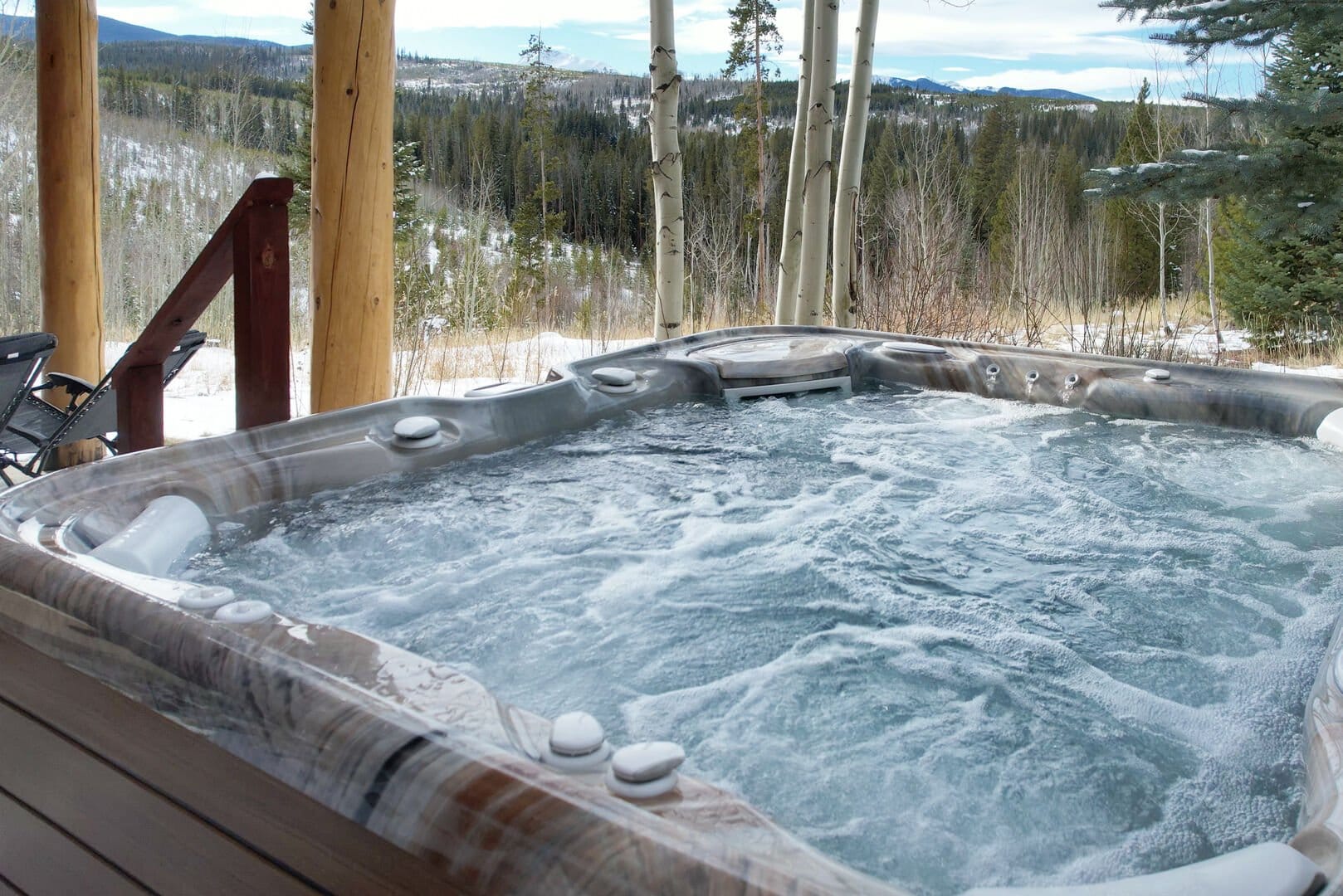 Outdoor hot tub with snowy view.