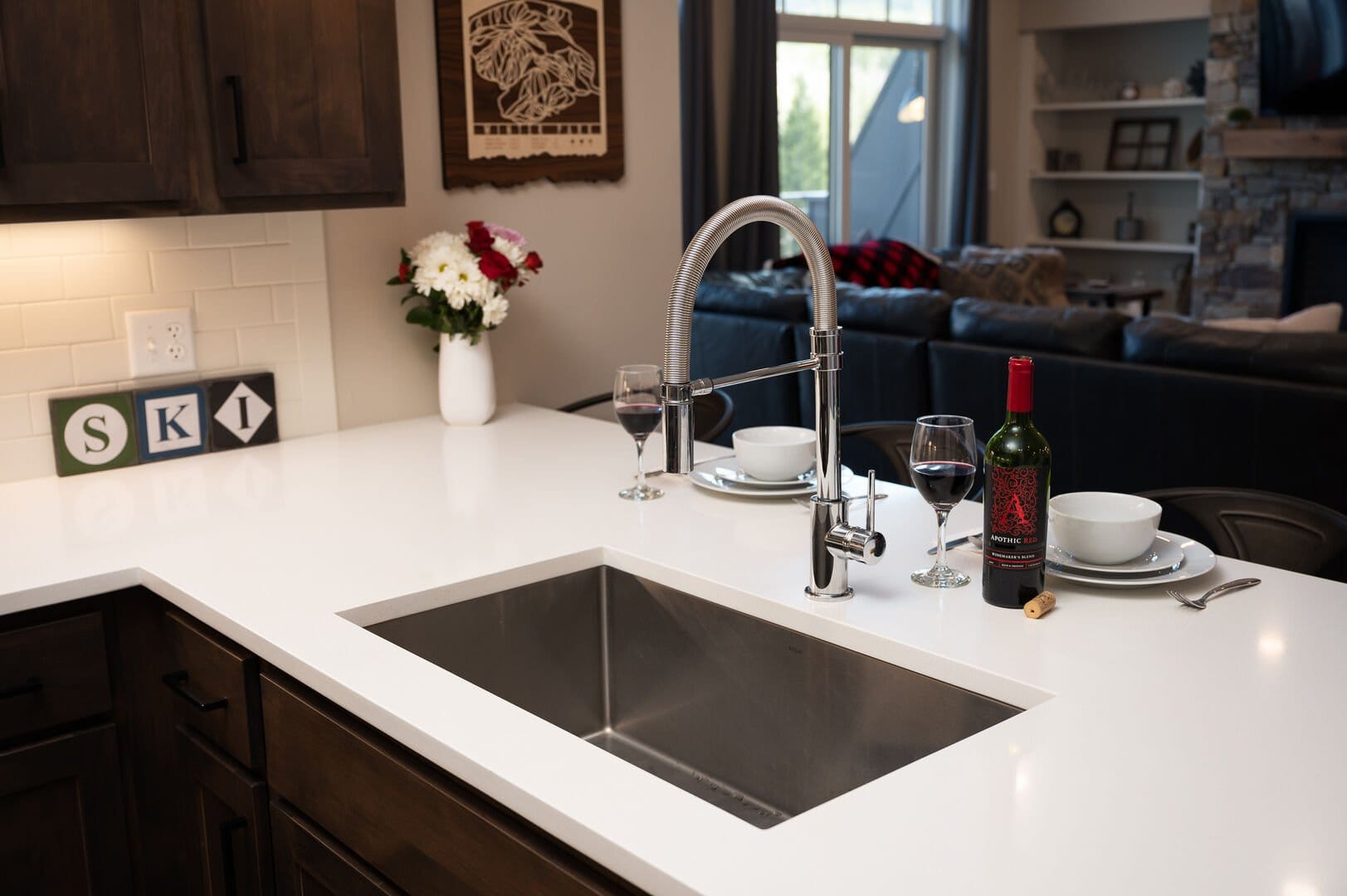 Modern kitchen with wine and flowers.