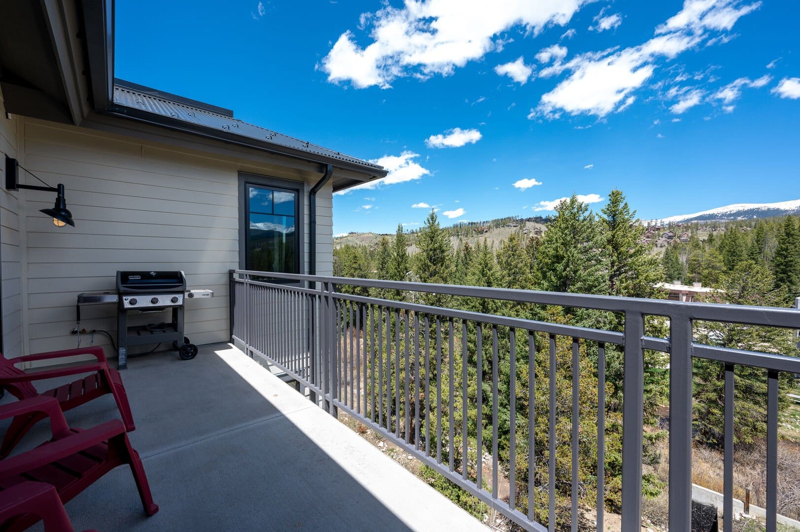 Balcony with grill overlooking mountains.