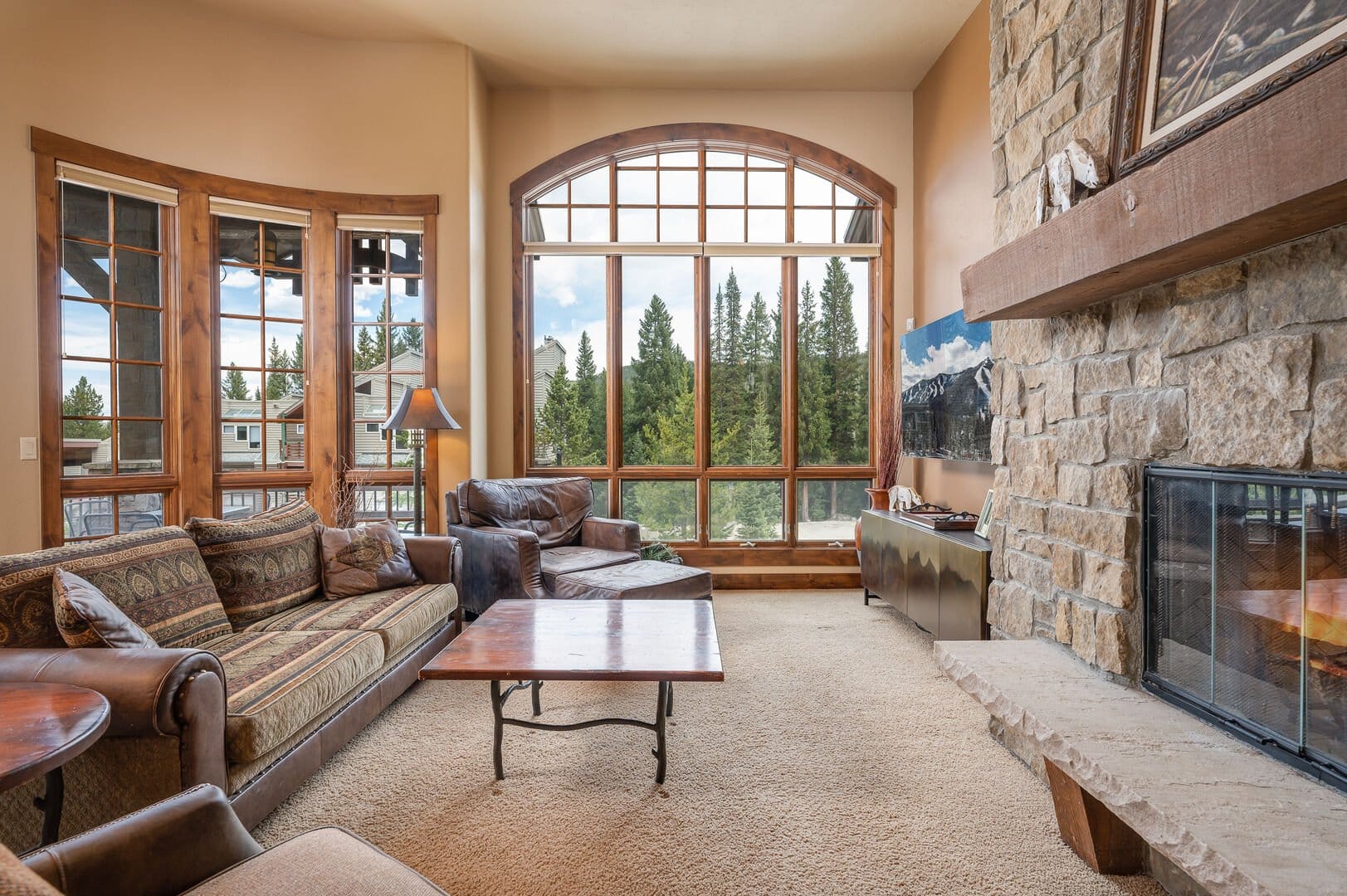 Rustic living room with large window.