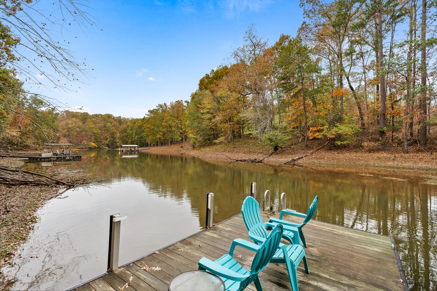 Lakeside dock with turquoise chairs.