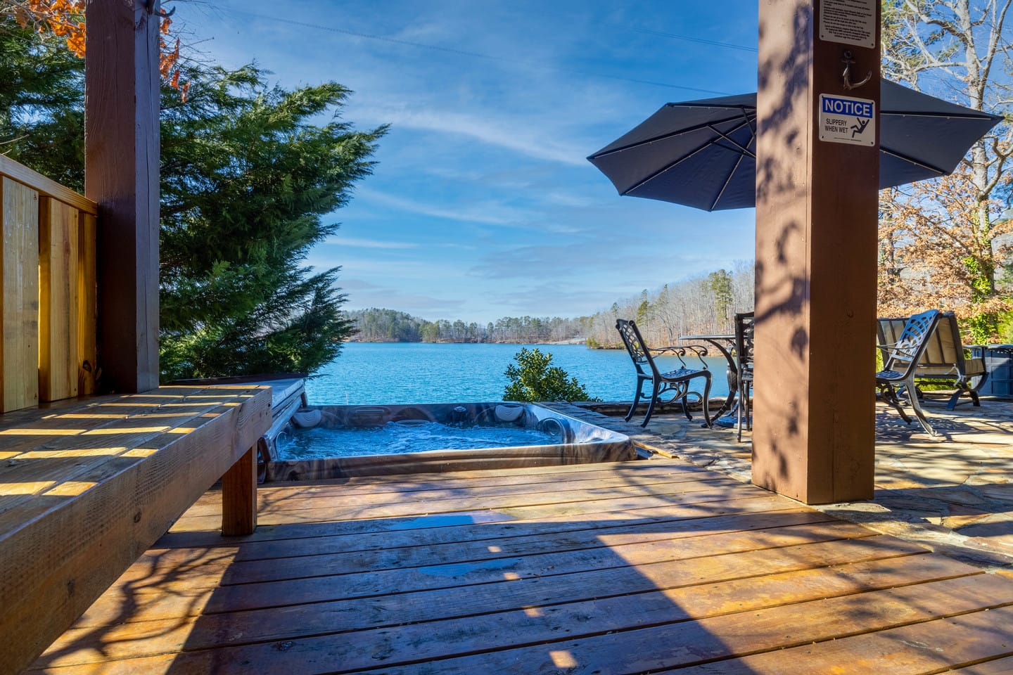 Patio with hot tub, lake view.