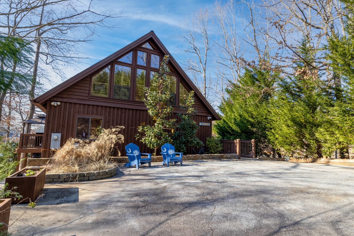 A-frame cabin with chairs outside.