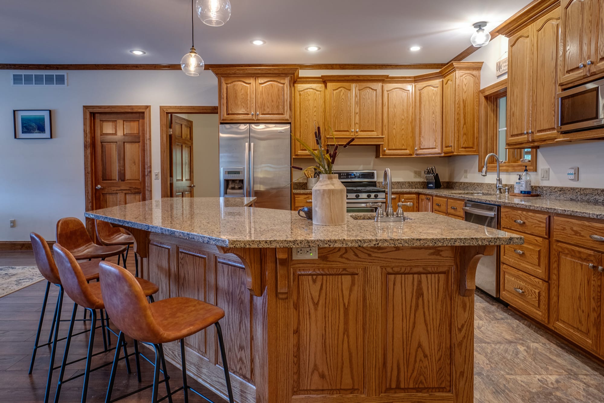 Wooden kitchen with bar stools.