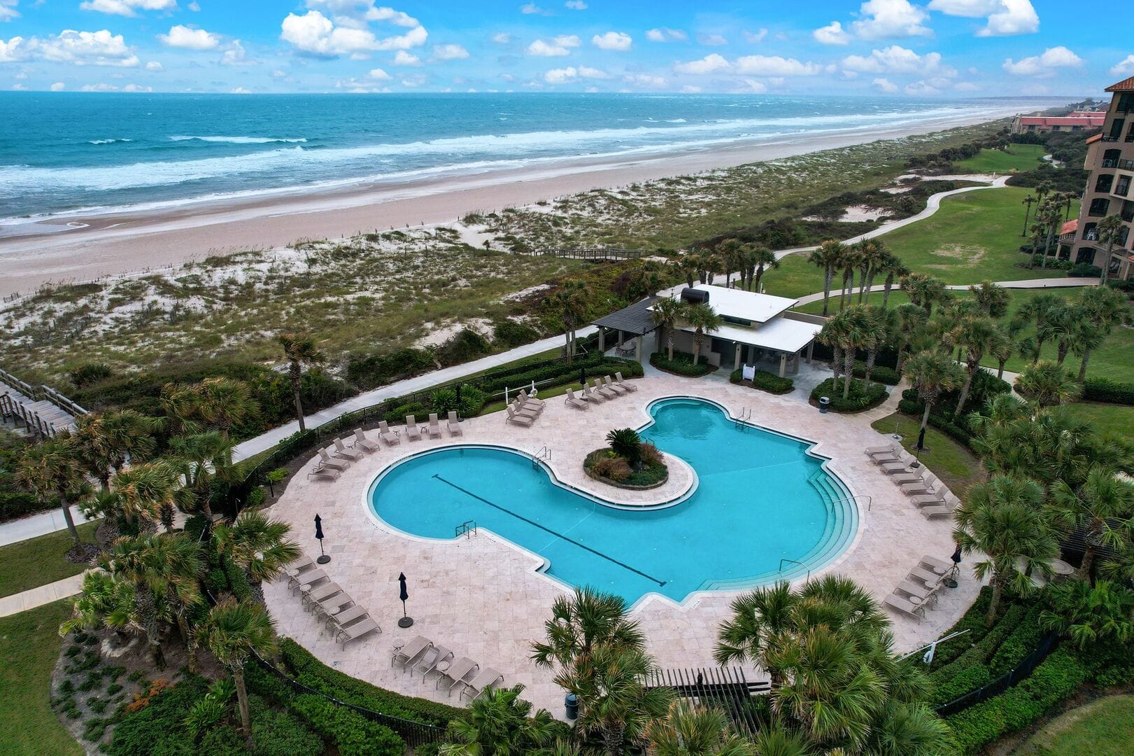 Beachfront resort pool and lounge area.