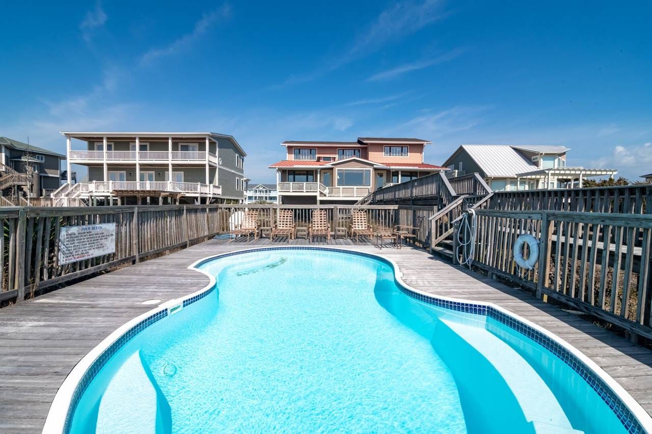 Pool with houses in background.